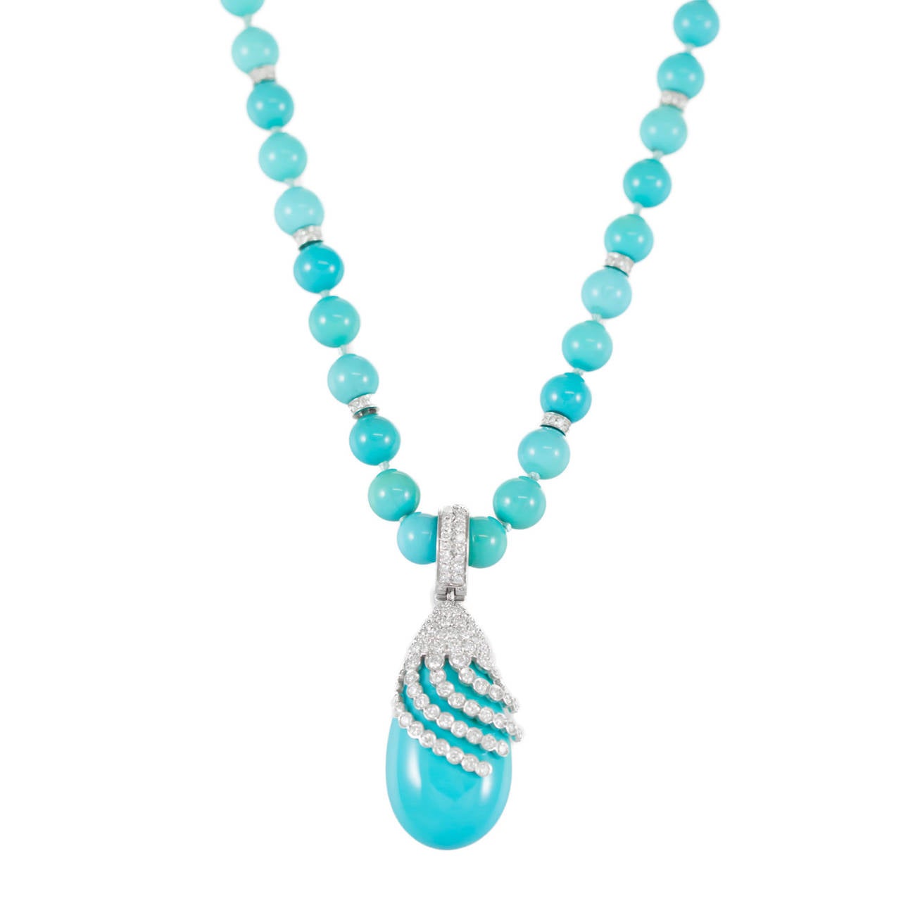 Lady's single strand fully knotted Spherical Bead Turquoise necklace with six white gold rondelles, bead-set with eight (8) Round Brilliant cut Diamonds in each, 14K white gold (stamped) hook clasp and a 14K white gold (stamped) enhancer, post-set