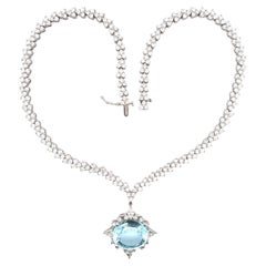 Collana tennis triangolare in oro bianco con ciondolo ovale rimovibile con topazio blu