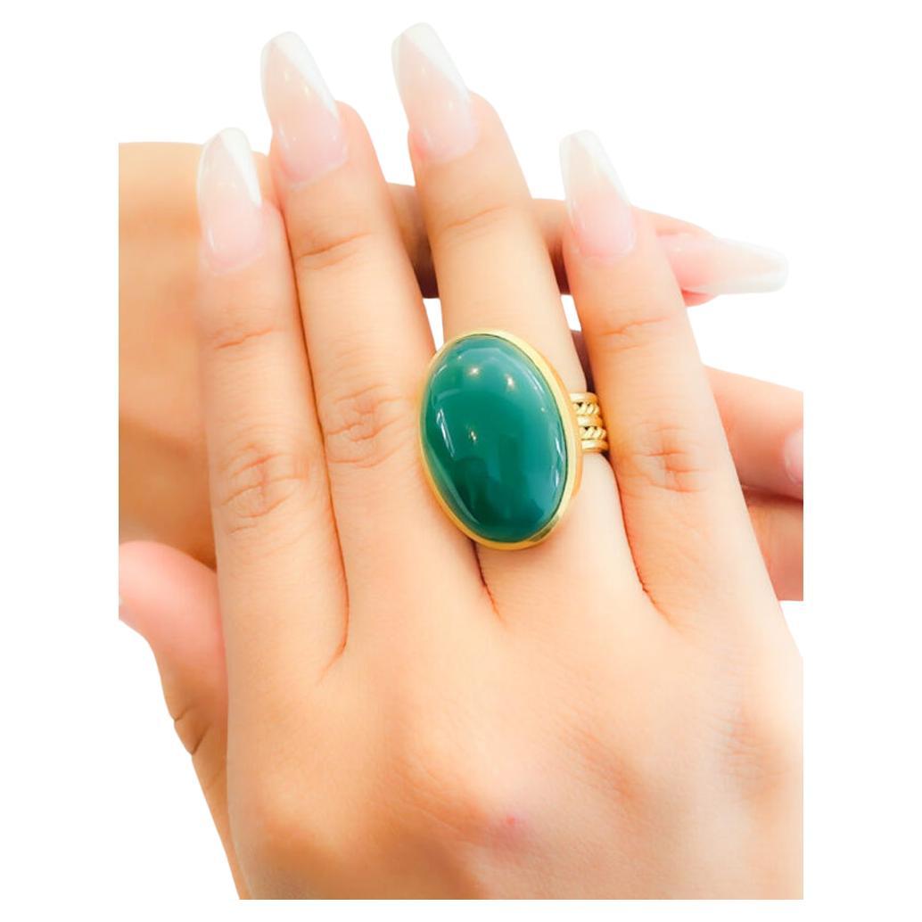Beautifully set green Agate cocktail ring set in 22K gold bezel and 20K gold twisted wire band. Simplicity at its best, modern yet timeless. Hand made, hand carved and one of a kind. The Tagili Promise: With every piece sold a portion of the