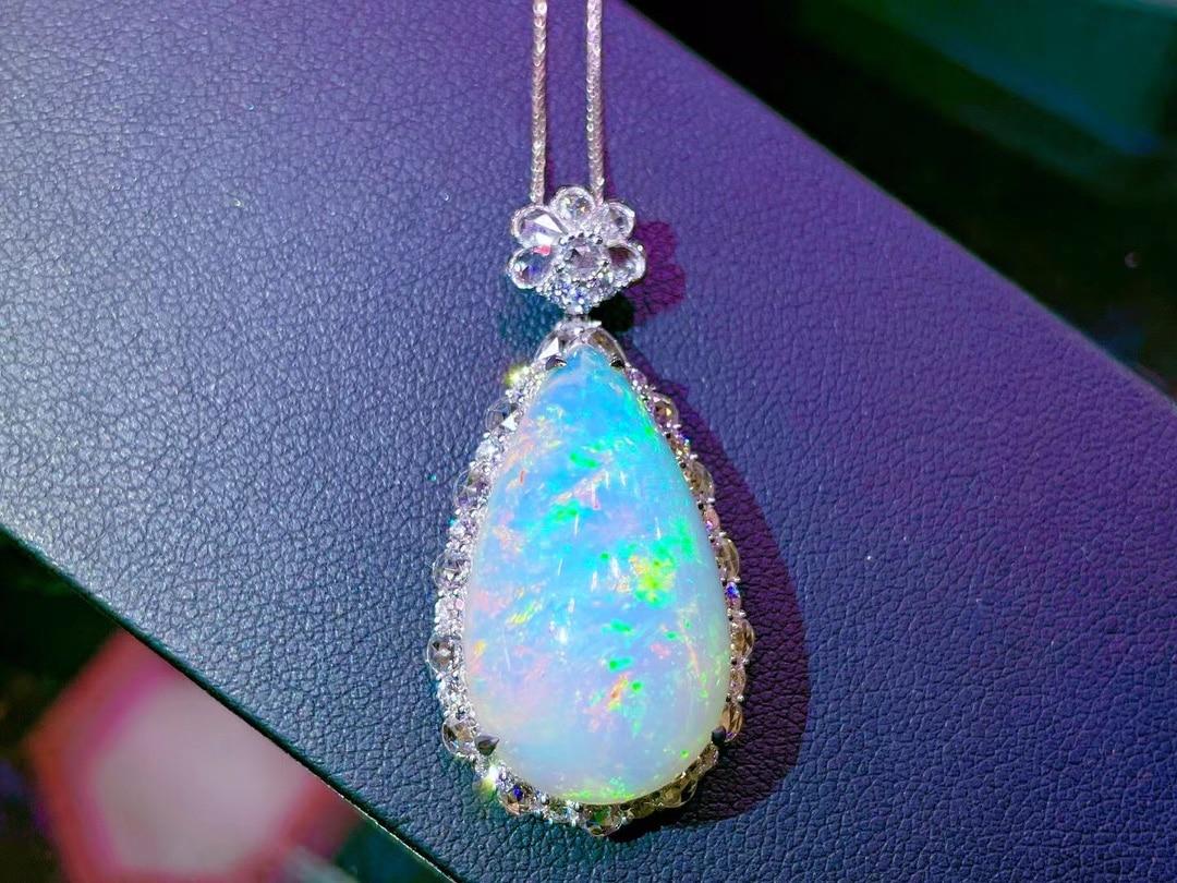 

This Ethiopian Opal shows off Very Bright Colors Blue Yellow Green  Pink Orange and stands out also with  Gemstones  including ones on the bail 

Ethiopian Opal is a new variety of opal discovered in Wollo province of Ethiopia. It is highly valued