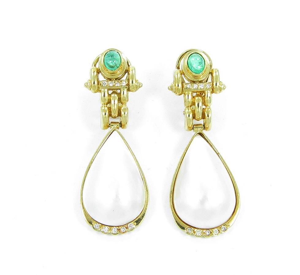 These beautiful Mabe Pearl earrings with emerald and diamonds are constructed in 14k yellow gold with omega backs. The Mabe Pearls measure approximately 23 x 14 x 6mm with very nice color flashes and in great condition. There are a total of 18