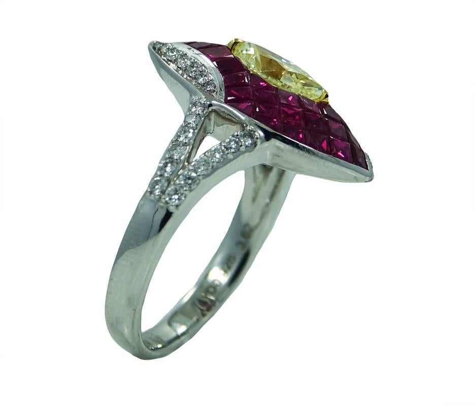 Platinum Ring With Invisible Set Princess Cut Rubies Weighing A Total Carat Weight Of 3.62ct, A Center Marquise Yellow Diamond Weighing A Total Carat Weight Of .92ct and Round Cut Diamonds Weighing A Total Carat Weight Of .35ct. This Ring Is a Size