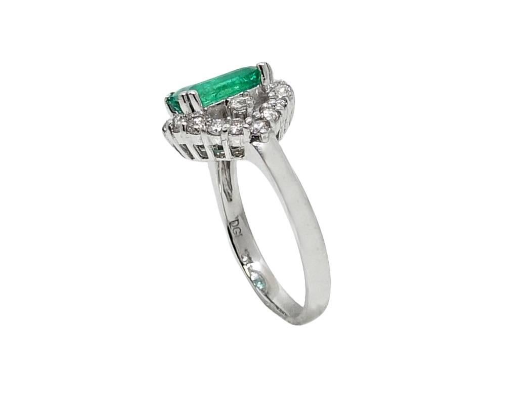 14K White Gold Ring With Center Emerald Cut Emerald Weighing A Total Carat Weight Of 1.83 Carats and Surrounding Diamonds Weighing A Total Carat Weight Of 0.78 Carats, H Color and VS Clarity. This Ring Is A Size 7 and Can Be Sized Upon Request. 