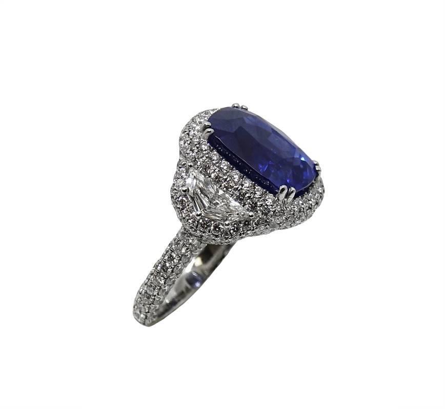 Platinum Ring With Center Heated Cushion Cut Sapphire Weighing A Total Carat Weight Of 11.49 Carats (GIA Report) This Ring Has Two Caddy Trap Sides, Micro Pave Infinity Edge and Surrounding White Diamonds Weighing A Total Carat Weight Of 4.23