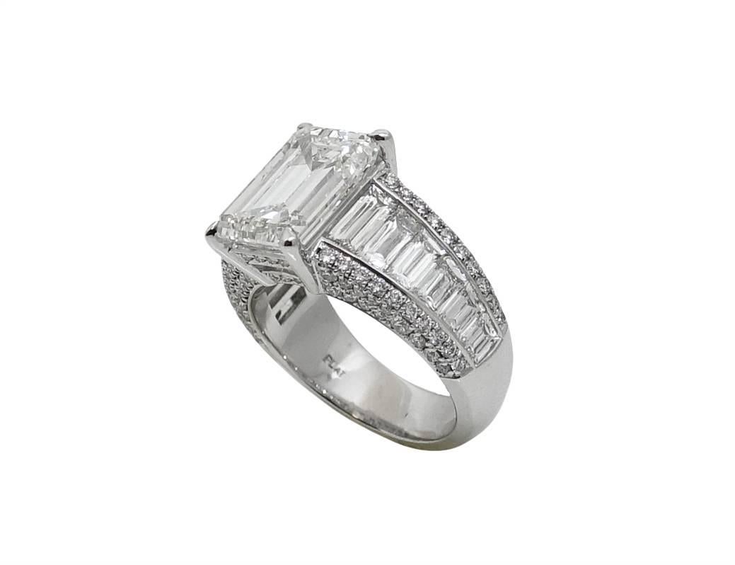 Platinum Ring With Large Center Emerald Cut Diamond Weighing A Total Carat Weight Of 5.01 Carats H in Color and VS1 Clarity (GIA Report). Channel Set Traps and Double Sided Micro Pave Weighing A Total Carat Weight Of 3.16 Carats. This Ring Is A Size