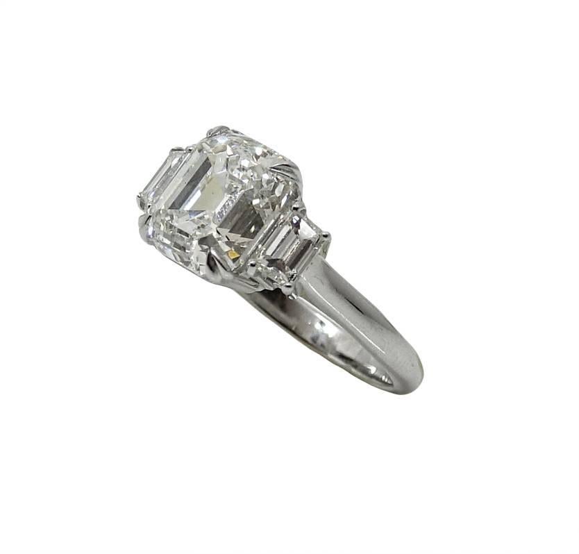 Platinum 3 Stone Ring With Center Emerald Cut Diamonds Weighing A Total Carat Weight Of 5.02 Carats  I Color and SI1 Clarity with GIA Report.  Two Side Diamonds Weighing A Total Carat Weight Of 0.92 Carats. This Ring Is A Size 6 and Can Be Sized