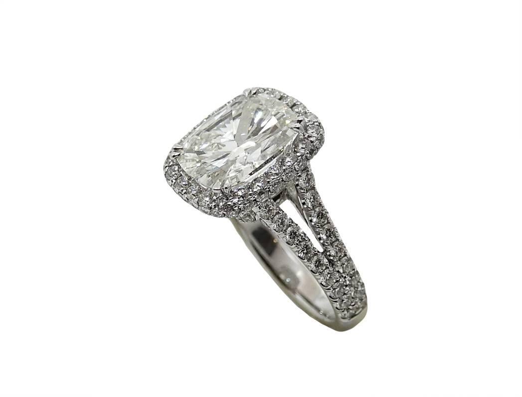 Platinum Ring With Center Cushion Cut Diamonds Weighing A Total Carat Weight Of 4.91 Carats, J Color and VS2 Clarity. (GIA Report). Mounting has 128 Round Diamonds Weighing A Total Carat Weight Of 1.85 Carats. This Ring Has A Pave Halo and Split