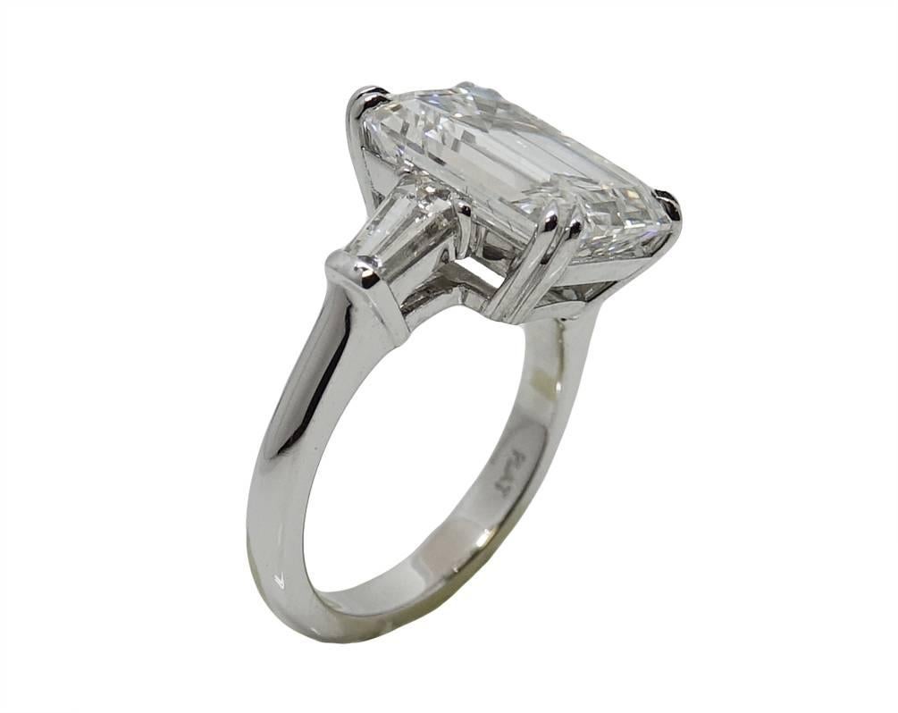Platinum Ring With Center Emerald Cut Diamond Weighing A Total Carat Weight Of 7.08 Carat, H Color and VS1 Clarity (GIA Report) Also has Two Tapper Baguette Side Diamonds Weighing A Total Carat Weight Of 0.87 Carats. This Ring Is A Size 6 and Can Be