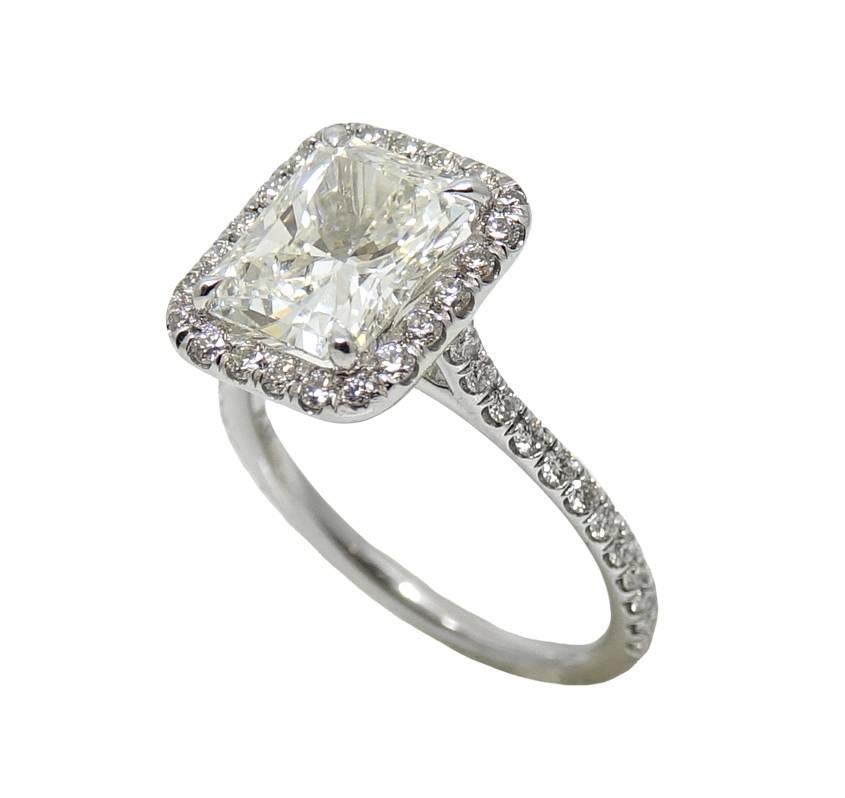 Platinum Ring With Center Radiant Cut Diamond Weighing A total Carat Weight Of 3.03 Carats, I Color and VS1 Clarity (GIA Report #:2207179780)  With Micro Pave Diamonds Covering The Halo and Shank Weighing A Total Carat Weight Of .70 carats. This