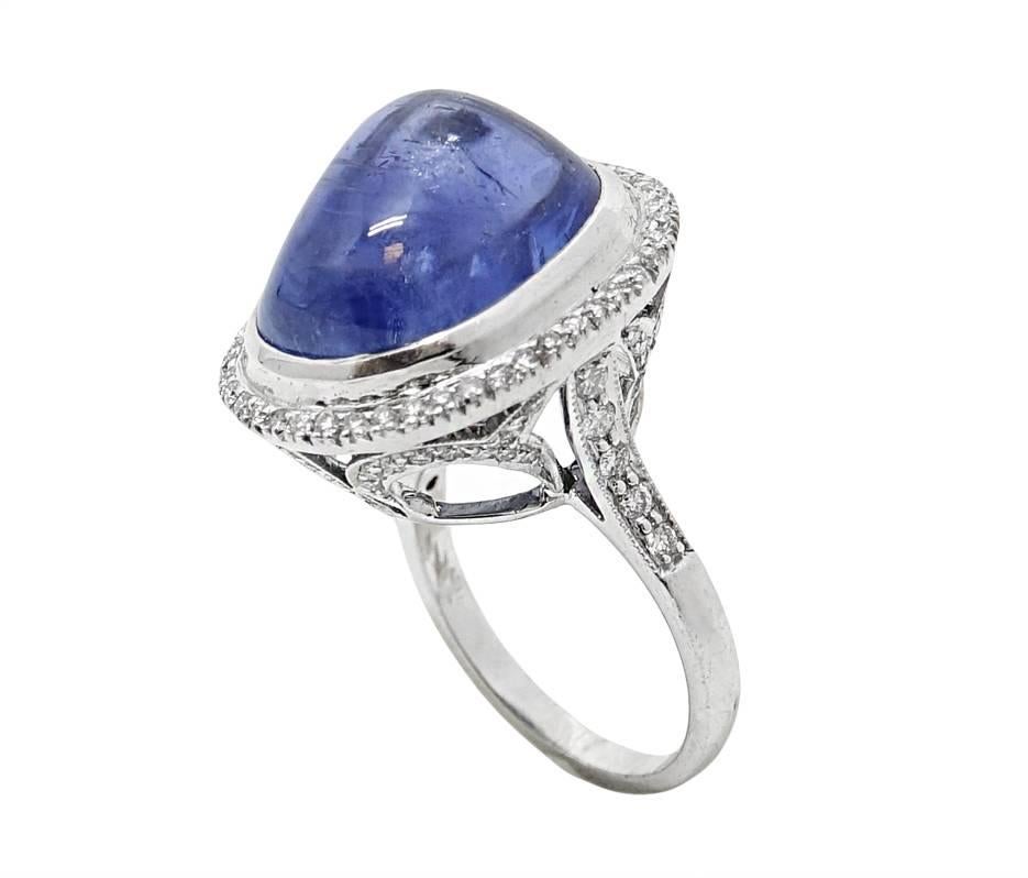 18K White Gold Ring With A Natural No Heat Burma Sapphire Weighing A Total Carat Weight Of 29.70 Carats and Diamonds Surrounding The Sapphire and Mounting Weighing A Total Carat Weight Of .90 Carats. This Ring Is A Size 6.5.