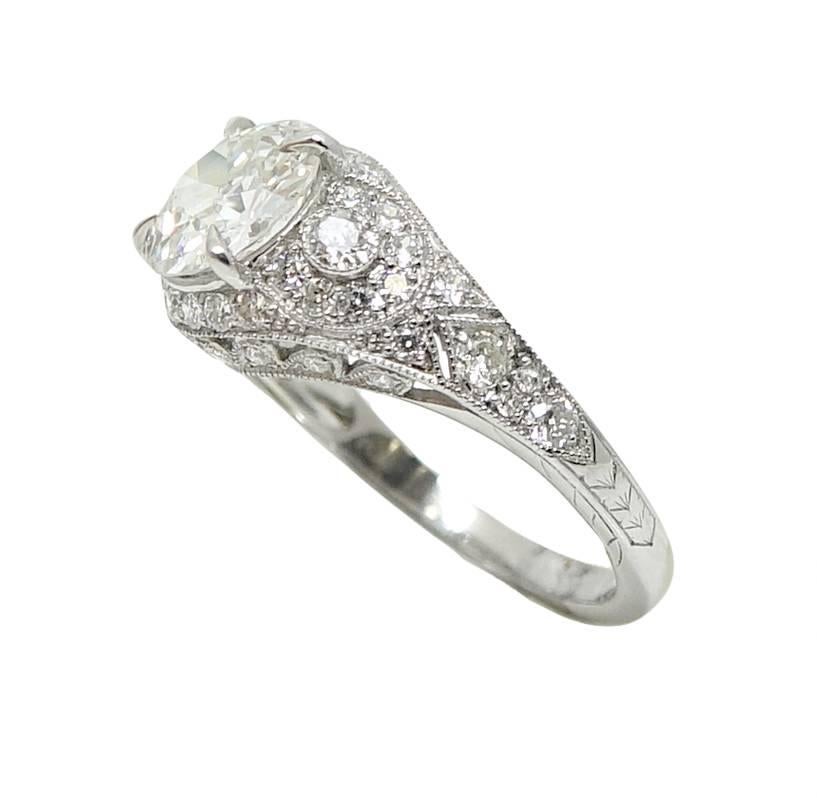 This Platinum Ring Has An Old European Cut Diamond In The Center Weighing A Total Carat Weight Of 1.61 Carats, F Color and SI2 Clairty. There Are 32 Round Cut Diamonds Around This Ring And Weigh A Total Carat Weight Of 0.66 Carats, G-H Color and