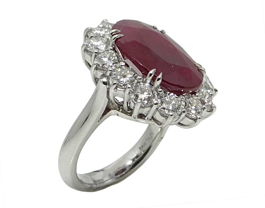 This Platinum Ring Has A Vibrant Oval Cut Ruby,HEATED (SIGNIFICANT RESIDUES) MINOR RESIDUES IN CAVITIES. In The Center Weighing A Total Carat Weight Of 10.18 Carats GIA Report #: 1176881858. There Are 14 Round Cut Diamonds Weighing A Total Carat
