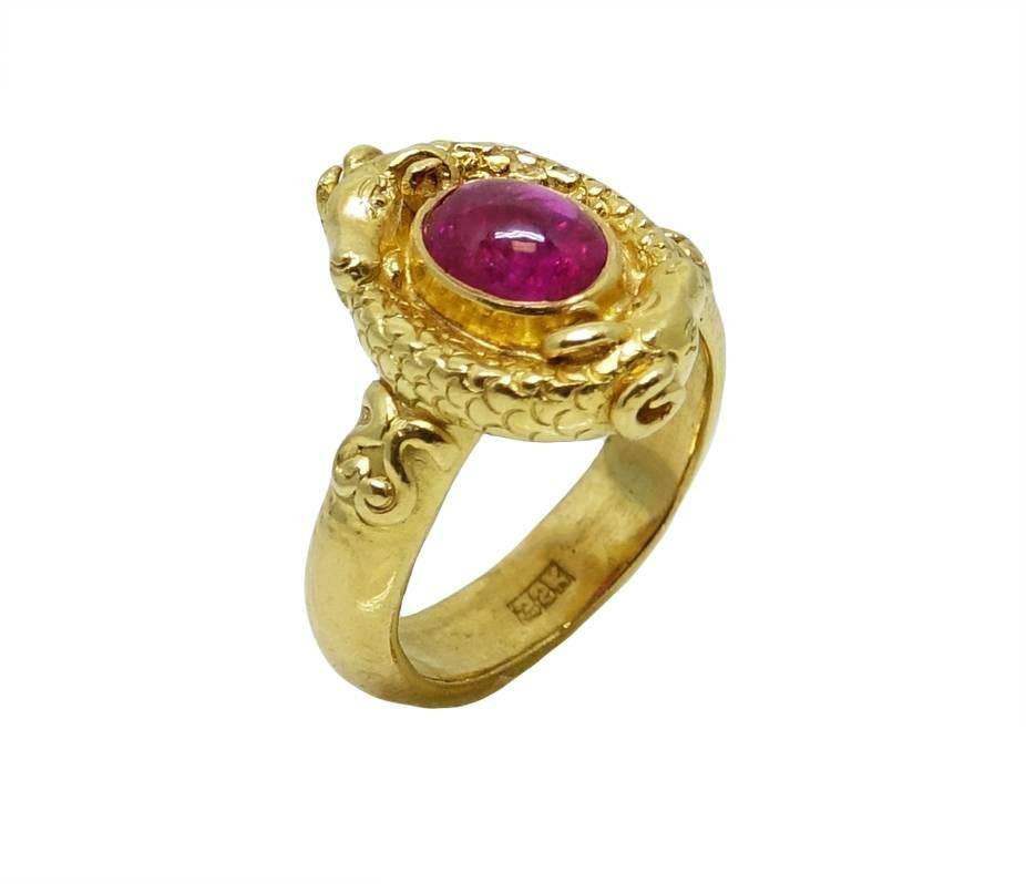 This 22K Yellow Gold Ring Has A Vibrant Cabochon Ruby In The Center Weighing A Total Carat Weight Of 1.50 Carats. Around The Ruby You'll See Creative Detailing Of Two Goat Heads. This Unique Ring Is A Size 7 And Can Be Sized Upon Request.