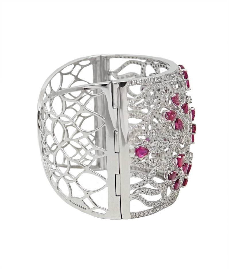 This Gorgeous 18K White Gold Cuff Bangle Is A Must have. The Cuff Has A Total Of 28 Gorgeous Rubies Spread Out Around The Bangle In Flower Shapes, These Rubies Weigh A Total Carat Weight Of 8.08 Carats. There Are 636 Sparkling Round Cut Diamonds