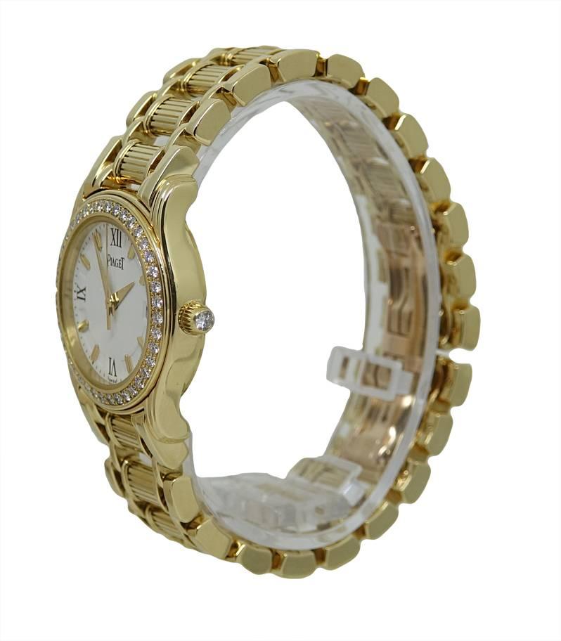 This 18K Yellow Gold Ladies Piaget Watch Is Part Of The Piaget Polo Collection. This Particular Model Has A White Dial With Roman Numeral and Yellow Gold Line Markers, A Date Indicator Is Also On The Dial. This Piaget Is 26mm With A Diamond Bezel