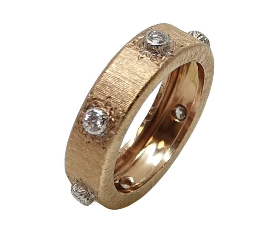 This Classic Buccelati Band Ring Is A Part Of The Classica Collection. This 18K Pink Gold Band Ring Has Approximately 6 Round Brilliant Cut Diamonds Weighing A Total Carat Weight Of .20 Carats. This Ring Is A Size 5.5.
On The Inside Of This Ring You