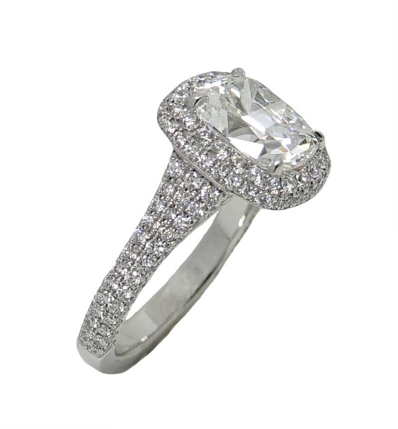 This Platinum Ring Has A Gorgeous Center Cushion Cut Diamond Weighing A Total Carat Weight Of 3.02 Carats, E Color and SI Clarity, GIA Report#: 2185057492. This Ring Has A Micro Pave Halo With Approximately 172 White Round Cut Diamonds Weighing A