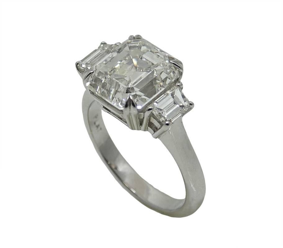 This Beautiful Platinum Ring Has a Center Emerald Cut Diamonds Weighing a Total Carat Weight Of 5.02 Carats. A Trap Diamond Is On Both Side Of The Center Diamond, These Two Diamond Have A Total Carat Weight Of .92 Carats.
This Ring Is A Size 6.5 and