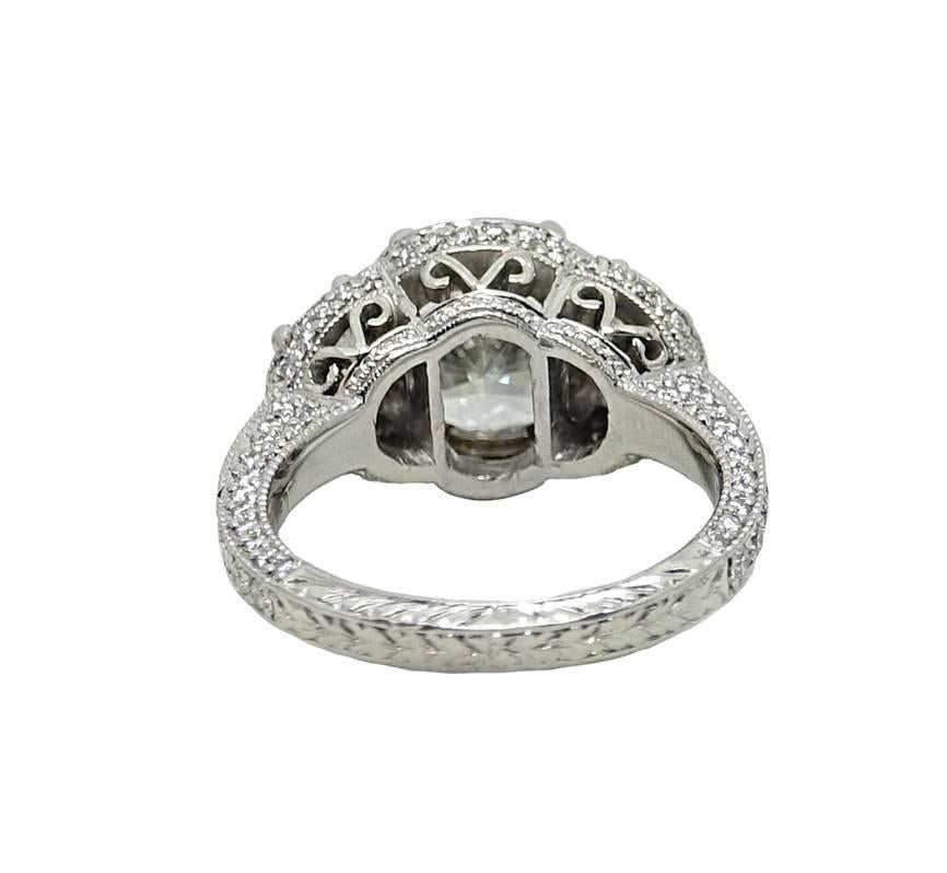 This Classy Three Stone Platinum Ring Has A Radiant Cut Diamond In The Center Weighing A Total Carat Weight Of 2.71 Carats, G Color and VVS2 Clarity. (GIA REPORT: 618307****) On Each Side Of The Center Diamond There Is A Half Moon Diamond, and Round
