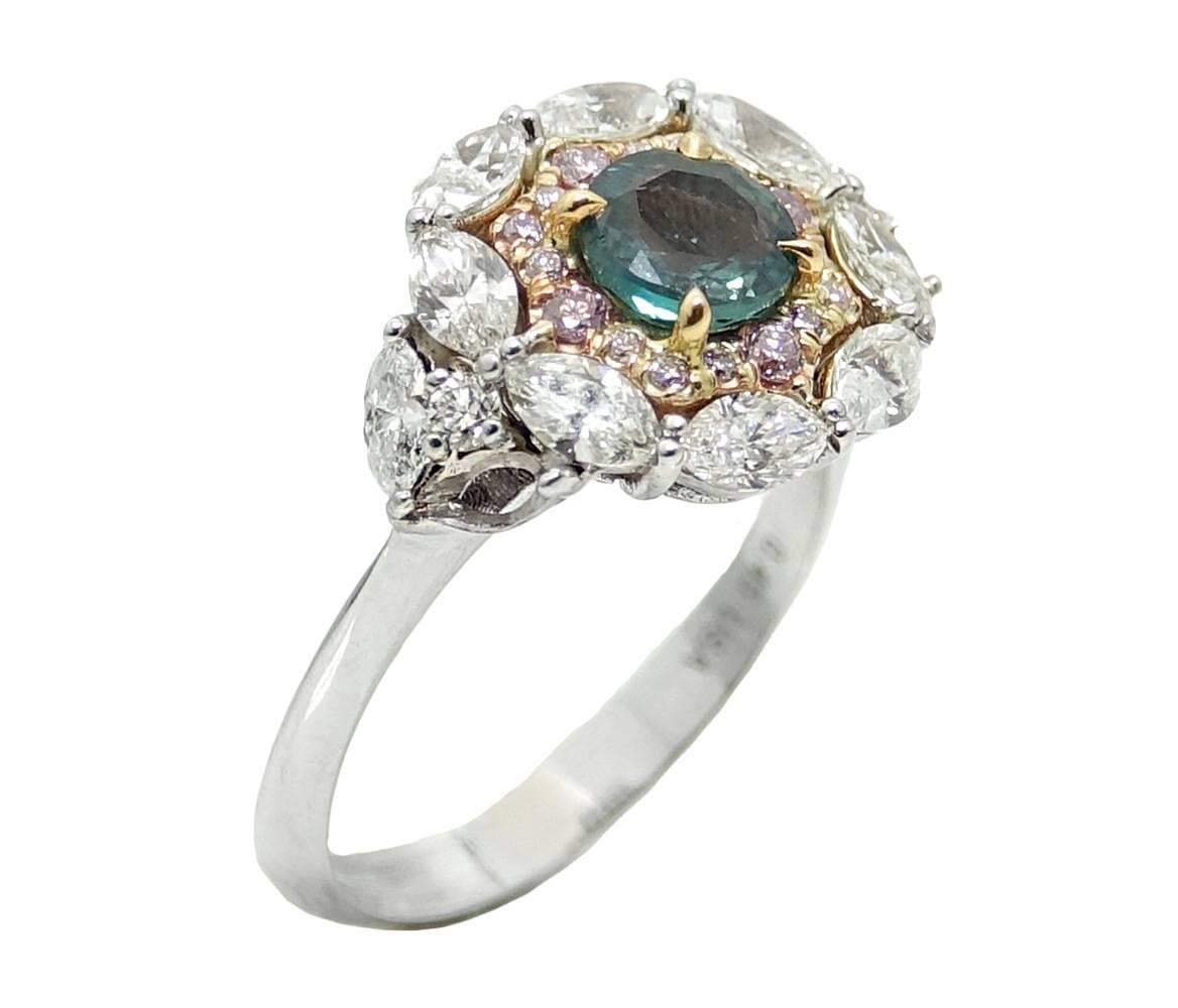 This Gorgeous 18K White Gold and Yellow Gold Ring Has A Center Alexandrite Stone Weighing A Total Carat Weight Of 0.78 Carats. 16 Natural Pink Diamonds Are Set In Yellow Gold Weighing A Total Carat Weight Of 1.90 Carats. These Pink Diamonds Look