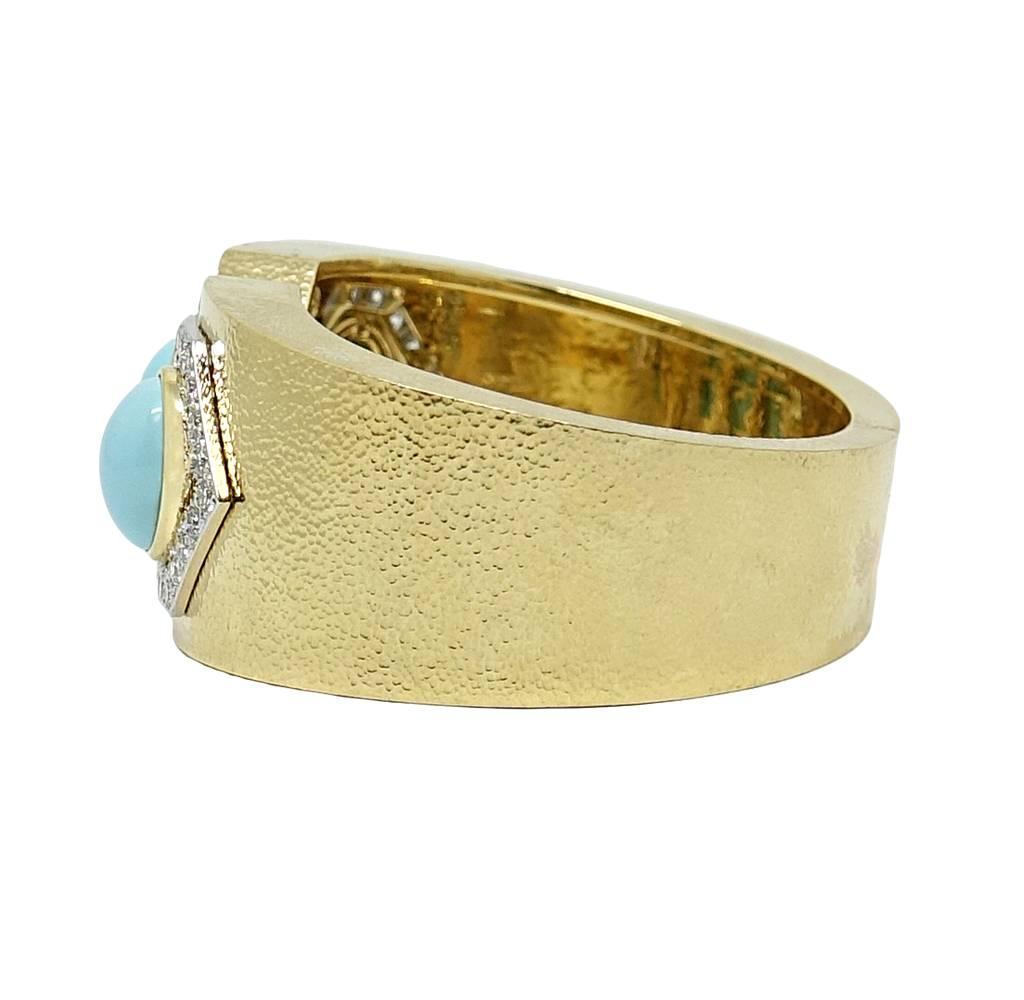 This Stunning and Chic David Webb Cuff Is 18K Yellow Gold and Platinum. Four Beautiful Oval Cabochon Turquoise Stones Are Set Perfectly In Yellow Gold. Each Stone Is Outlined By Sparkling Diamonds Weighing A Total Carat Weight Of 4.15 Carats. This