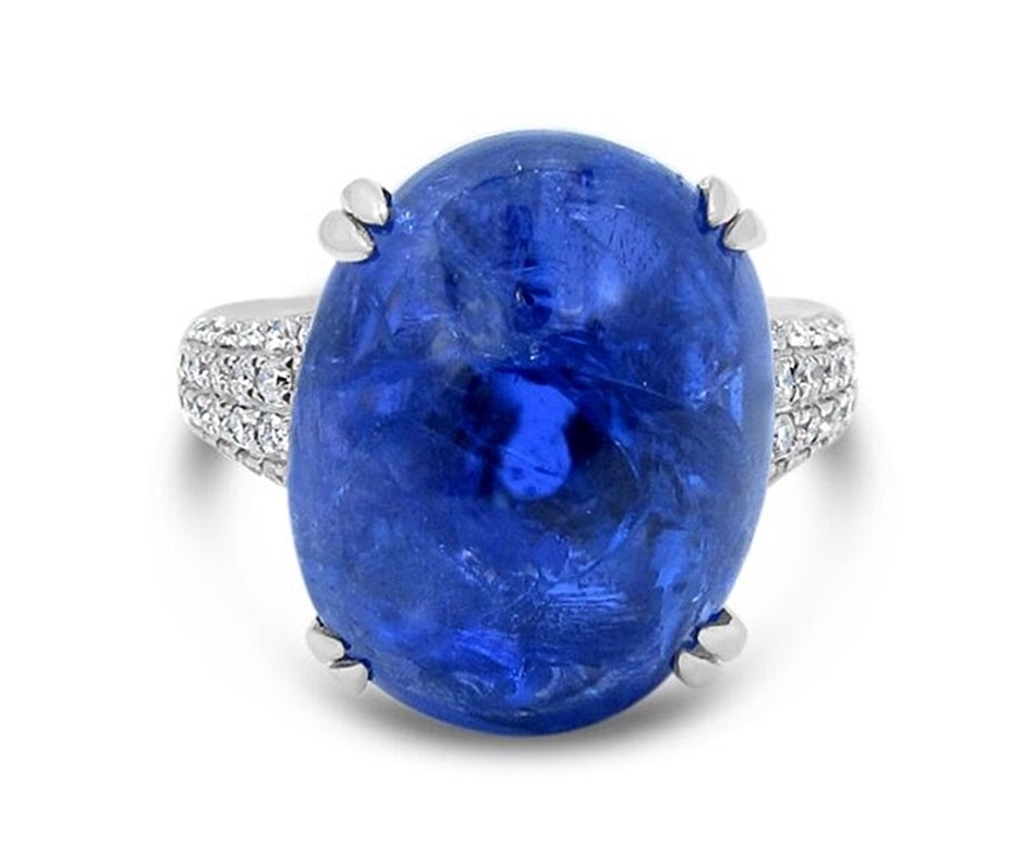 We are pleased to offer this beautiful 23ct Tanzanite Cabachon with diamonds in 14k white gold. Tanzanite measure approximately 14mm x 18mm x 10mm. Gemstone has a beautiful purple blue hue. The Characteristics of this stone make it come to life with