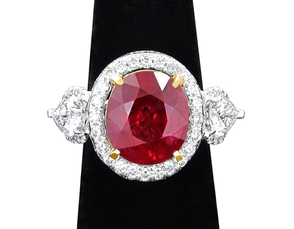 Mozambique Oval Ruby weighs 8.54cts and is certified by GRS. The two side pear shaped diamonds are .82cts and .80cts and are both certified by GIA. This is a beautiful ring and the ruby has fantastic color. 

Emailed certifications for Ruby and