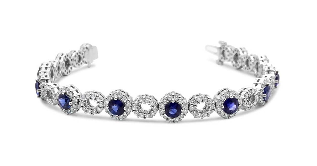 This Exquisite Sapphire and Diamond Bracelet has vibrant sapphires and brilliant diamonds.  There are 12 Round prong set Sapphires weighing ~5.84cttw.  264 Round Full Cut Diamonds surround and make up the connecting links throughout the bracelet. 