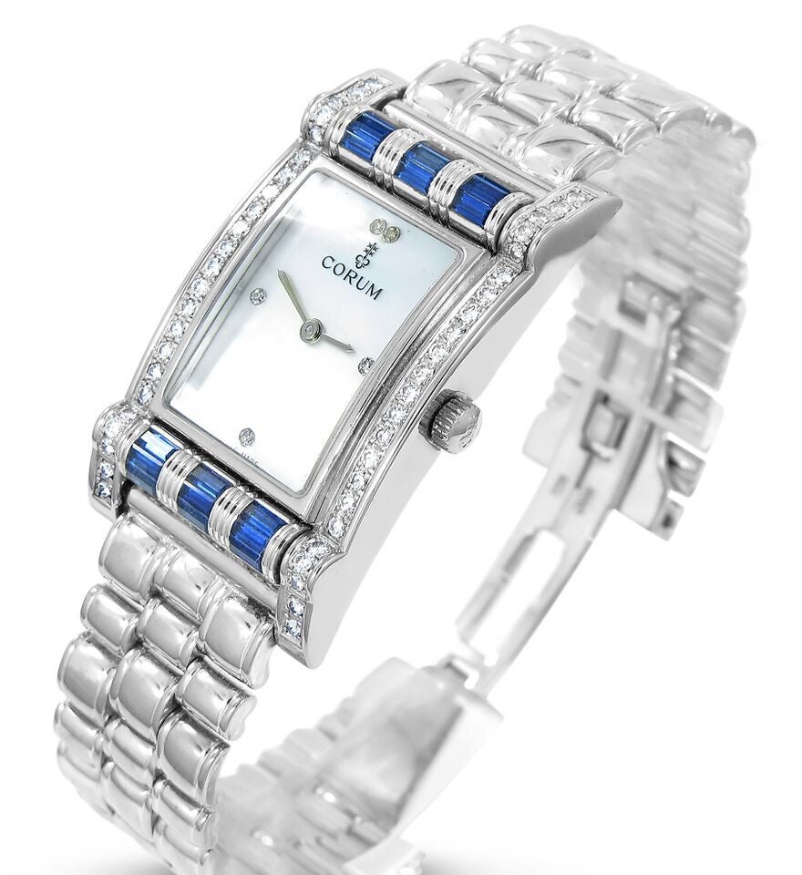 Up for auction is this gorgeous and unusual lady's Corum watch. This exceptional timepiece is made from 18k white gold and features a mother-of-pearl dial with diamond markers. It has 22 diamonds on each side of the bezel,and rotating rondelles at