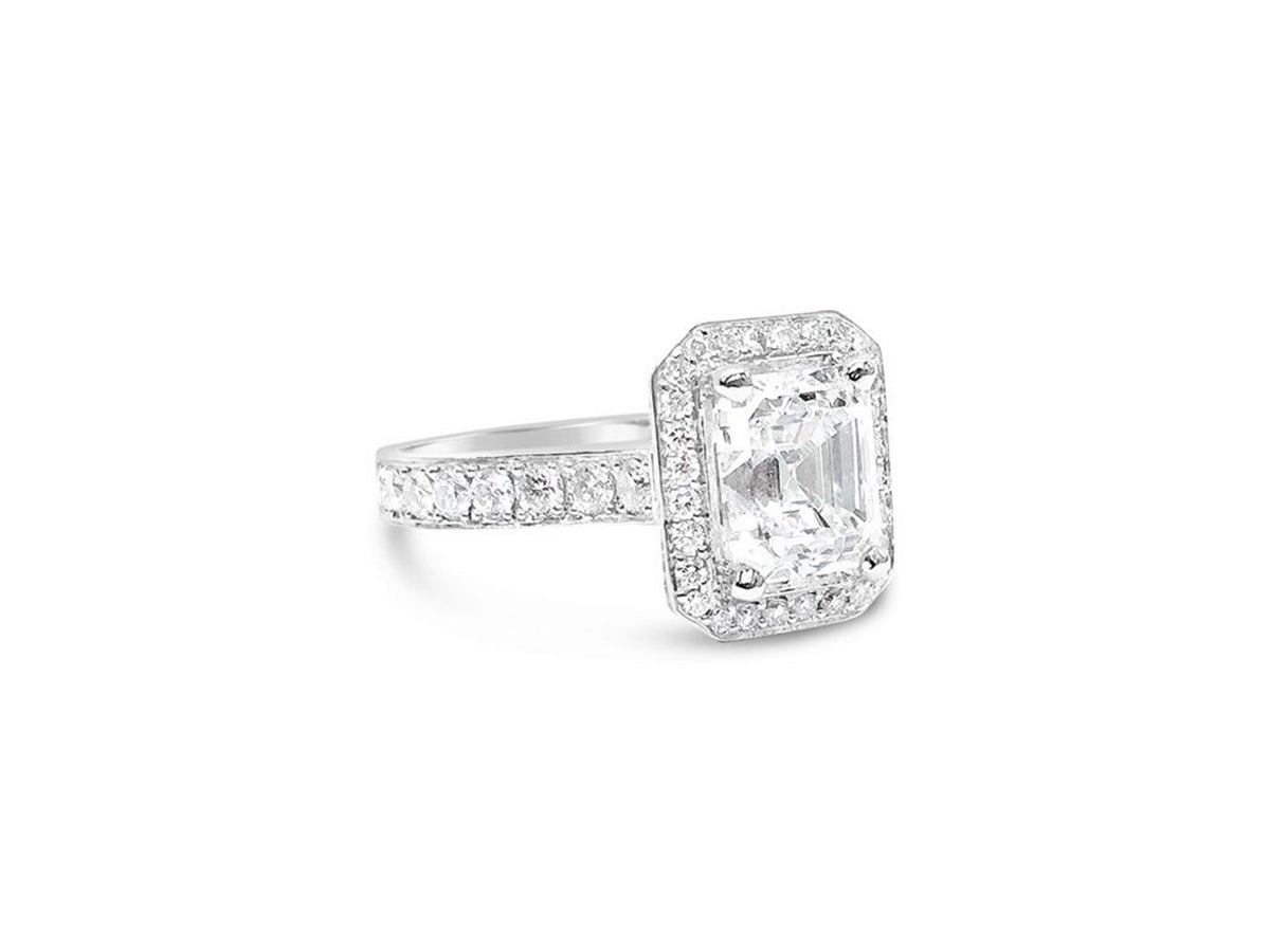 Up for sale is a beautiful 2.47ct Emerald Cut diamond in a modern style micro-pave halo mounting in 18kw Gold with 226 diamonds ~1.68 ctw.  throughout the top and sides. This GIA Certified  2.47ct.Center Emerald Cut Diamond is a VS1 Clarity and E