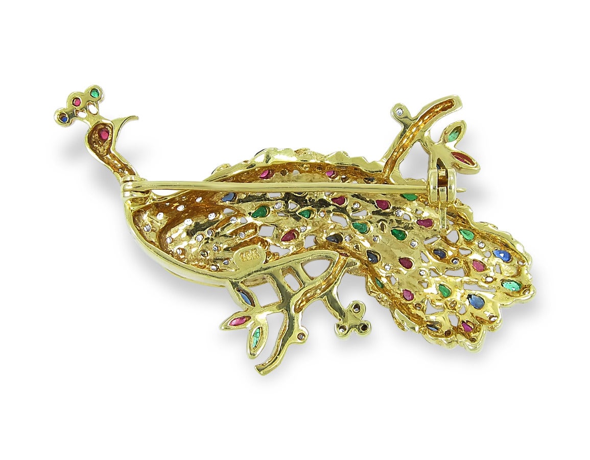 Up for sale is this beautiful estate peacock pin. There are a mixture of sapphires, rubies, emeralds and diamonds all set in a way that makes this peacock come to life. There is an approximate 4.40ctw. This pin measures 2 1/4