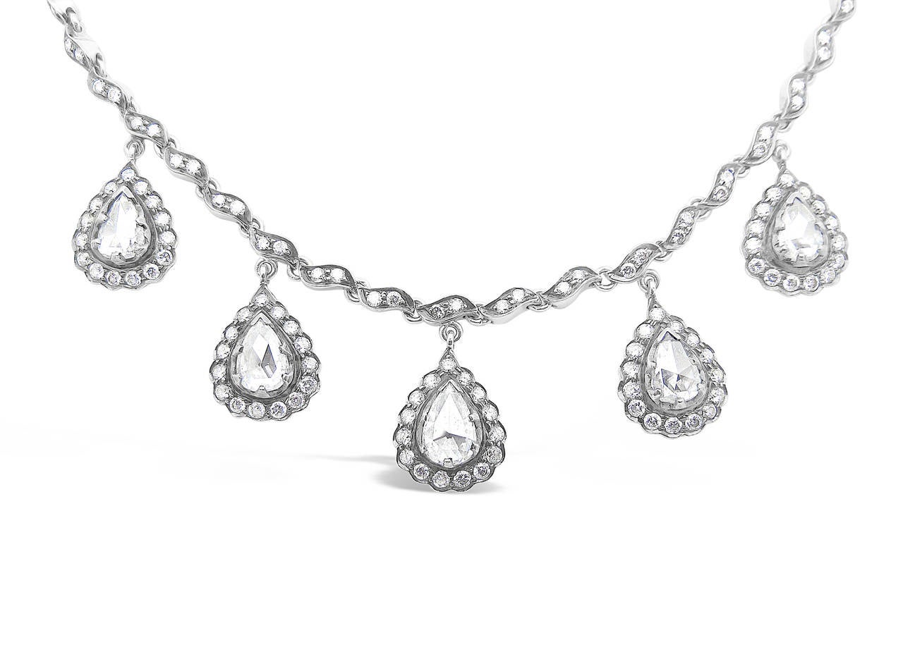 Here is a beautiful necklace by Sethi Couture with Rose Cut Pear Shaped diamonds. Each pear shaped diamond is approximately .90cts. There are approximately 209  round diamonds which stretch from one end to the other on the necklace including a halo
