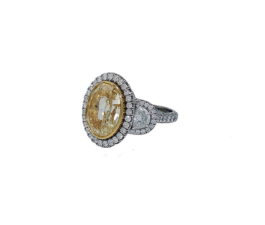 Platinum and 18K Yellow Gold Engagement Ring with a Fancy Intense Yellow Diamond=7.06ct SI1 EGL-US Cert#906848301D and Two Half Moon Diamonds=.75ct. The mounting has 271 Round Brilliant Diamonds=2.25ct total weight,