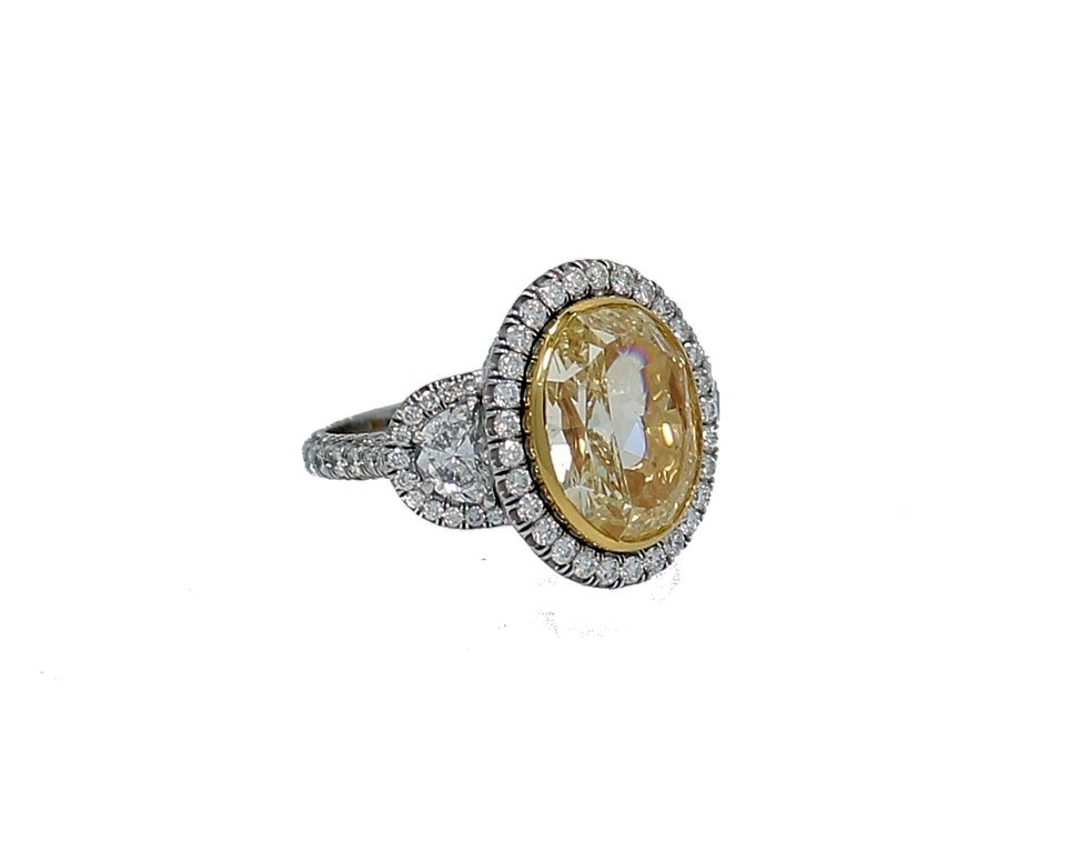 7.06 Carat Fancy Intense Yellow Oval Diamond Engagement Ring In New Condition For Sale In Naples, FL