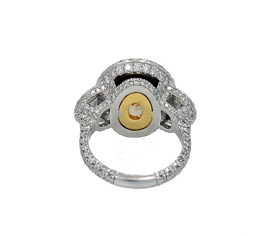 Women's 7.06 Carat Fancy Intense Yellow Oval Diamond Engagement Ring For Sale