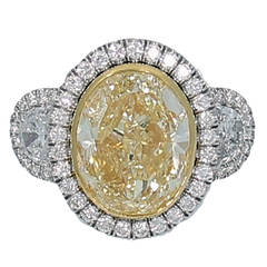 7.06 Carat Fancy Intense Yellow Oval Diamond Engagement Ring