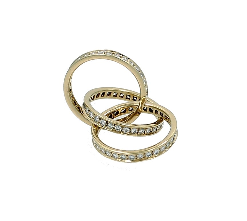 Cartier Trinity three bands intertwined in this unique design. The Ring is in Yellow Gold with a total of 1.70 carats in diamonds and is a size 4 1/2. A timeless Cartier Original.