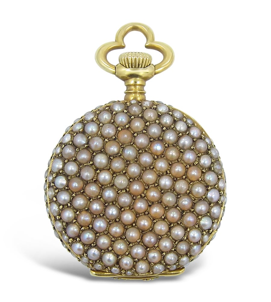 This is a very beautiful and well put together custom pocket watch by an unknown creator. Pearl seeds average size is 1.65mm and all are accounted for. Very few have slight cracks or chips as you can see from the pictures and all are prong set with