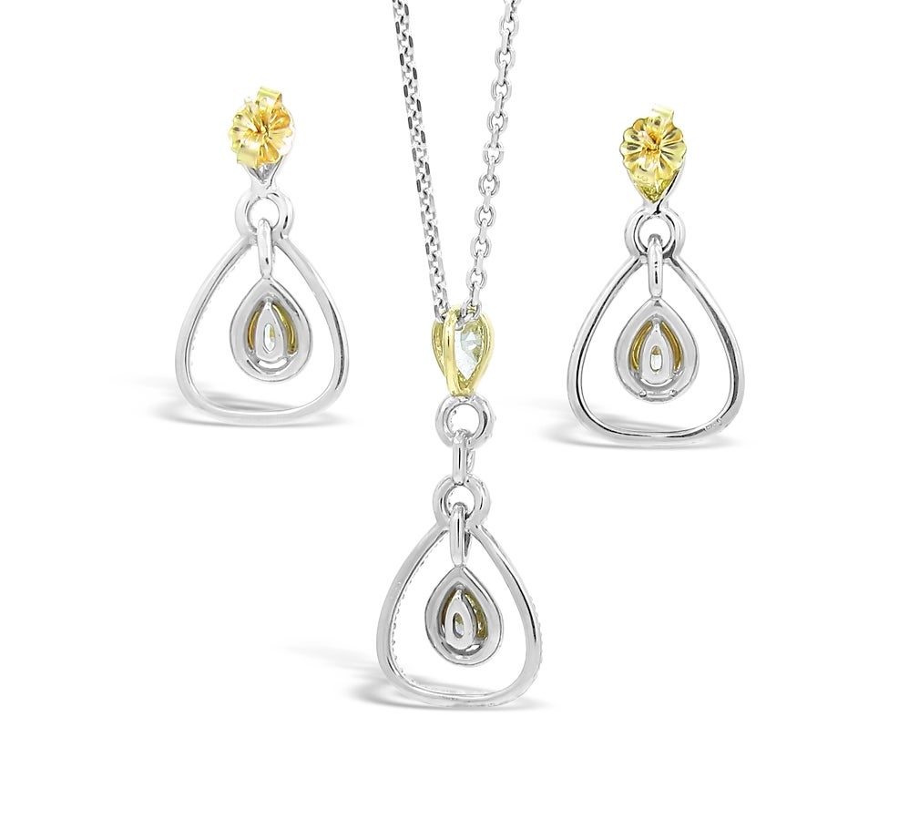 Here is a fantastic set of Fancy Yellow pear shape diamonds and white diamonds creating a very unique and stylish set. Pendant and earring match except for the additional circle of diamonds on the pendant. 
All Pear shape fancy yellow diamonds are