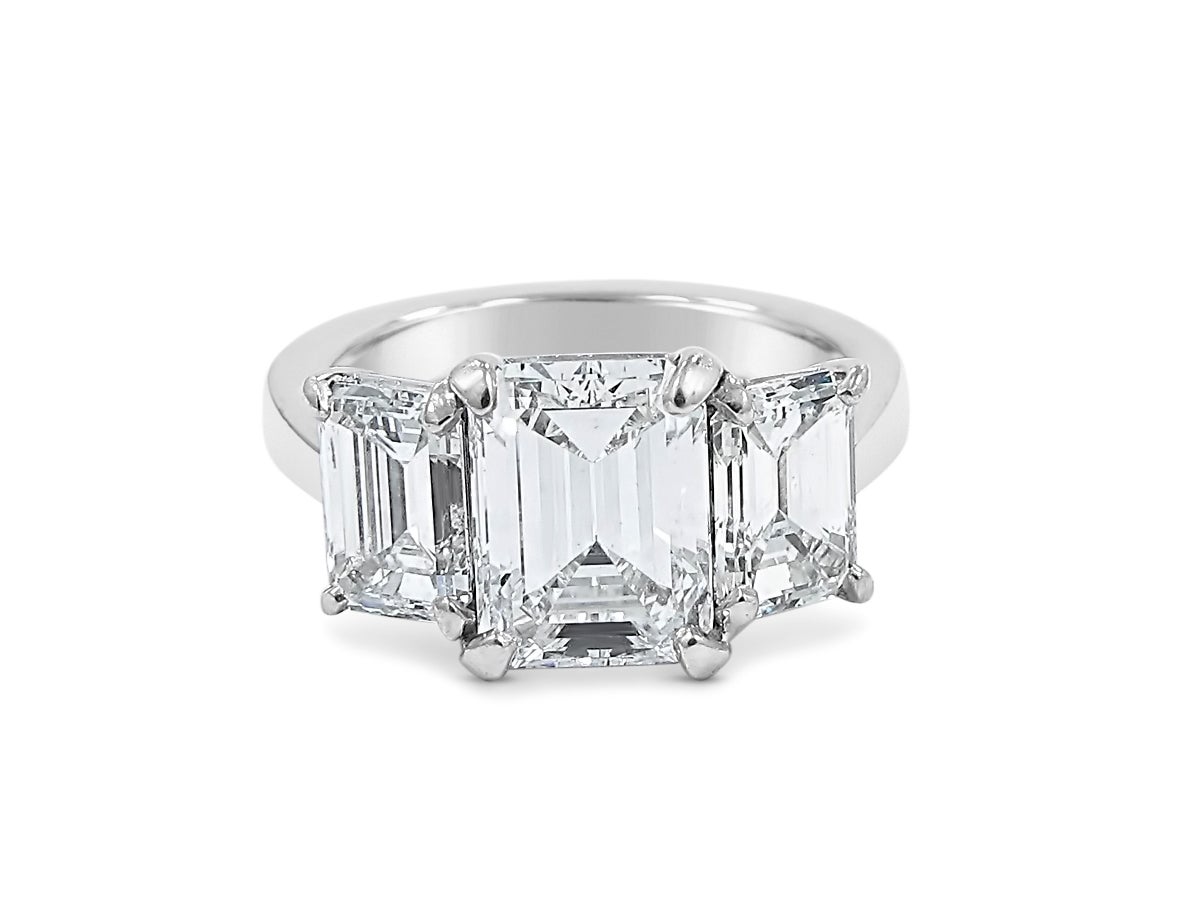 Here is a beautiful Emerald Cut Diamond engagement ring. Center Emerald cut diamond is GIA Report at a 2.45ct E, VVS2 (GIA Report # 2151695984). Side diamonds are approximately 1ct each with same quality but not certified, giving this ring a total
