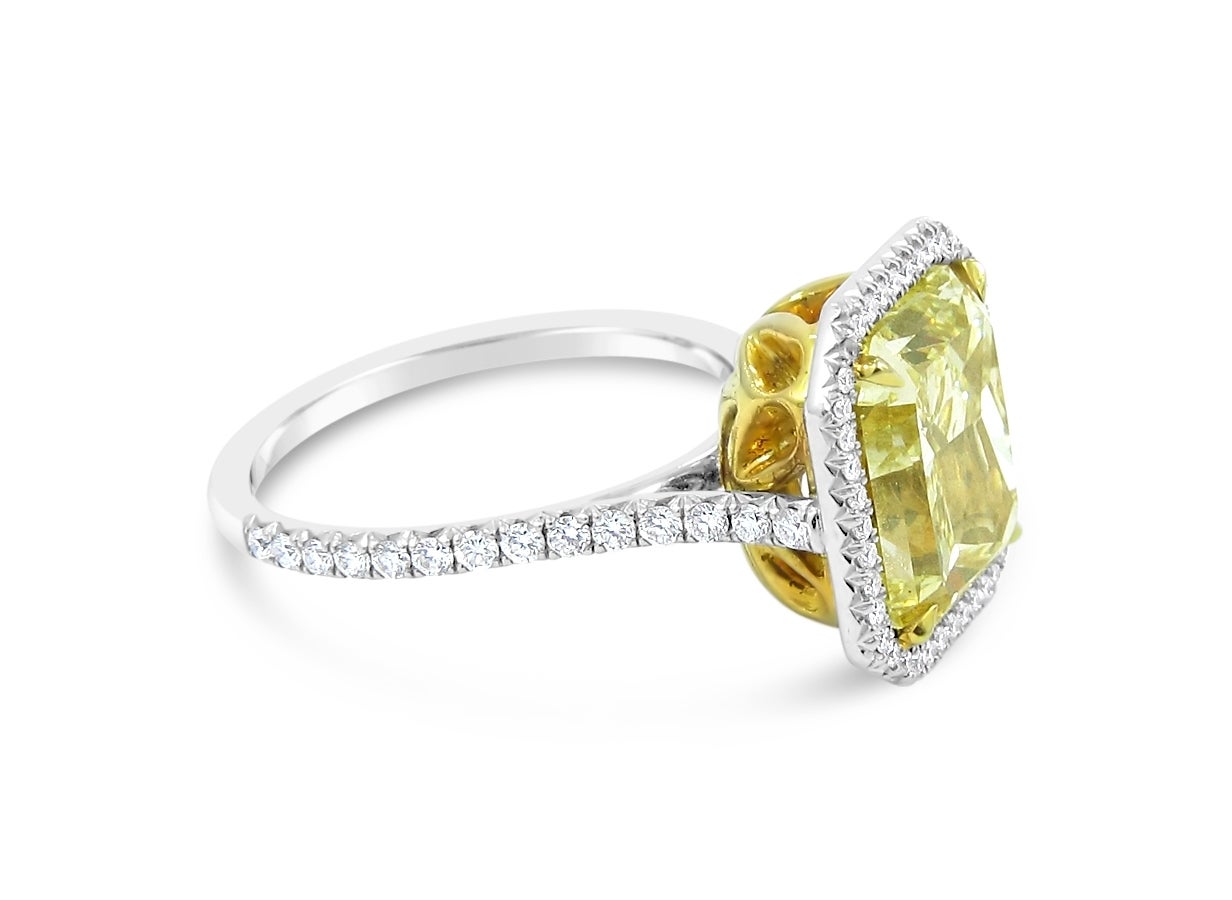 Here is a beautiful Fancy Yellow Diamond engagement ring. Center diamond in a Cut Cornered Rectangular Modified Brilliant GIA Report Fancy Yellow Diamond with VS1 Clarity. GIA Report # 15310187. 
Fancy Yellow diamond is set in 18k yellow gold