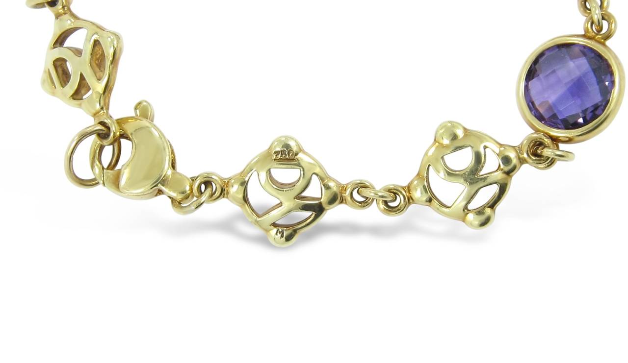 This is a David Yurman Signature link Bracelet. There are two amethyst gemstones and one pink tourmaline. Each gemstone has a dimension of approximately 8mm. Bracelet measures 7.25 inches in length and is made of 18k yellow gold.