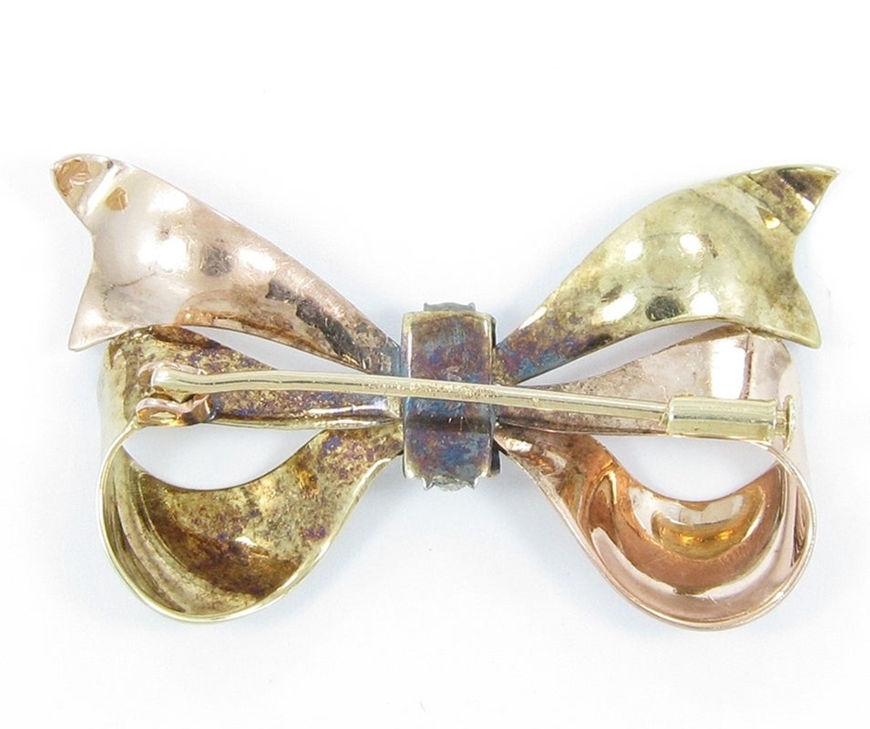 Up for sale is this beautiful antique bow pin in 14k yellow and rose gold with 6 rose cut diamonds which equal approximately .20ctw. Pin measures 1 1/2
