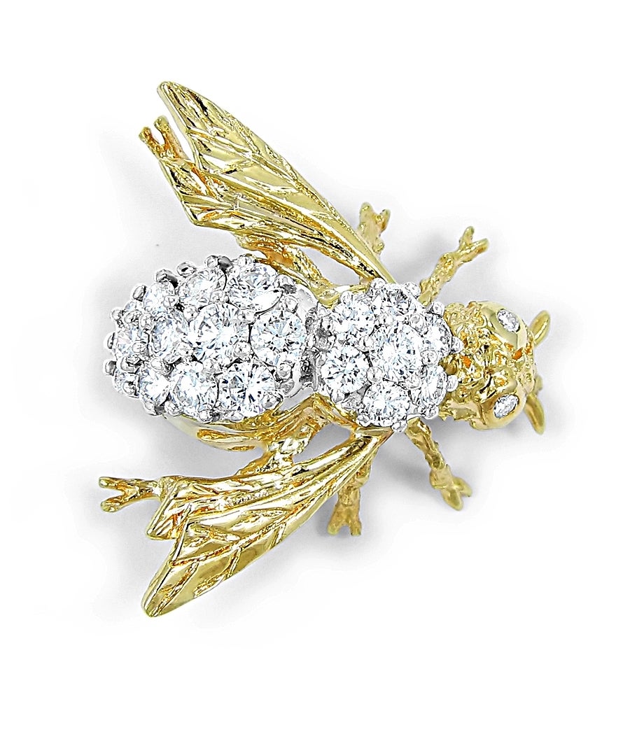Very well made bumble bee brooch made with 18k white and yellow gold. There are 21 round brilliant diamonds, set in white gold, of different sizes which equal approximately 2ctw. This is very fine craftsmanship. Bee measures 1 inch from top of head