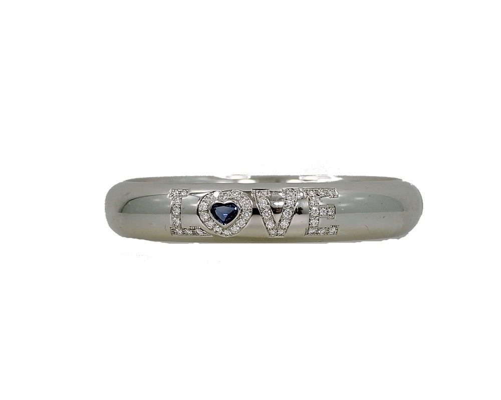 Stunning Chopard Bangle Bracelet with 43 Round Brillant Diamonds .82ct total weight and a heart shape blue Sapphire .83ct. This Chopard piece is in pristine condition and comes with original box and Certificate.