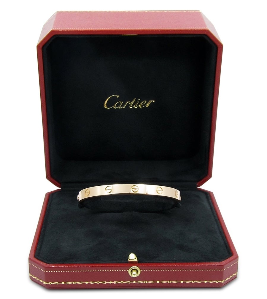This is a beautiful luxury piece made by Cartier. This Cartier Love Bracelet is crafted from 18k rose gold, high polish and features two screws for opening and closing. Perfect for an every day wear. This bracelet is size 18 and will come in its