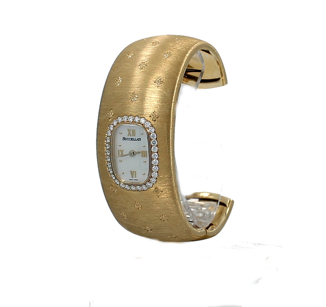 Buccellati Yellow Gold Cuff Bracelet Watch, Cleopatra Engraving, 25MM, White Mother of Pearl, Quartz Movement With 32 Diamonds=~0.72ctw.,Engraved Losanghe Bizantine.  SN:12032 W0801177