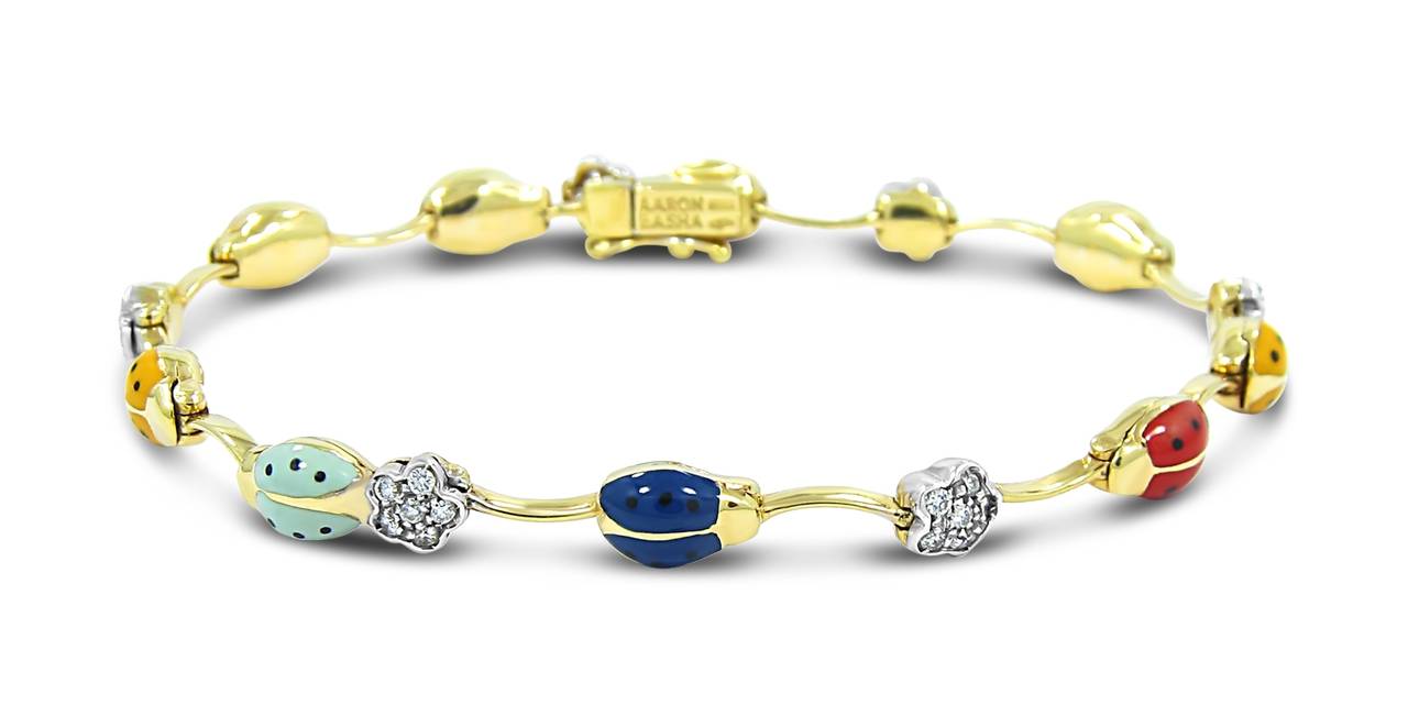This is a fantastic example of the Aaron Basha designs. Enameling is perfect on these lady bugs. Bracelet if made of 14k yellow and white gold. There are 36 round brilliant cut diamonds in the shape of flowers all prong set in 14k white gold. There