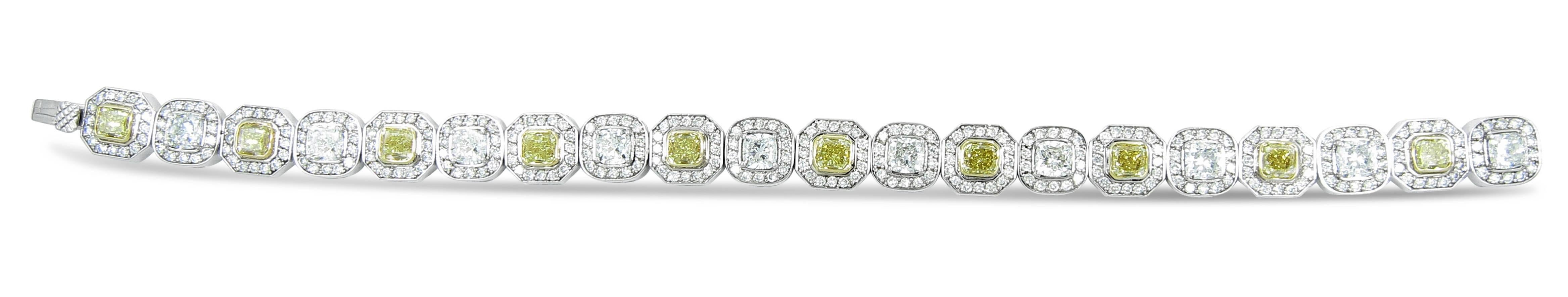 Beautiful bracelet is in 18k white gold with halo style alternating fancy yellow and white cushion cut diamonds with pave set round diamonds around each cushion cut diamond.
Fancy Yellow Cushion Cut Diamonds are SI1 in Clarity - 5.58ctw
Cushion