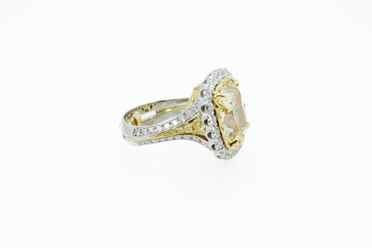 Platinum and 18K Yellow Gold Christopher Design Ring with a Crisscut 10.09 carat Fancy Yellow Diamond Clarity SI1 Center Stone. GIA Report# 0000. The mounting has 2.39 carats total weight of Round Brilliant Cut Diamonds. The ring is a size 6.5.